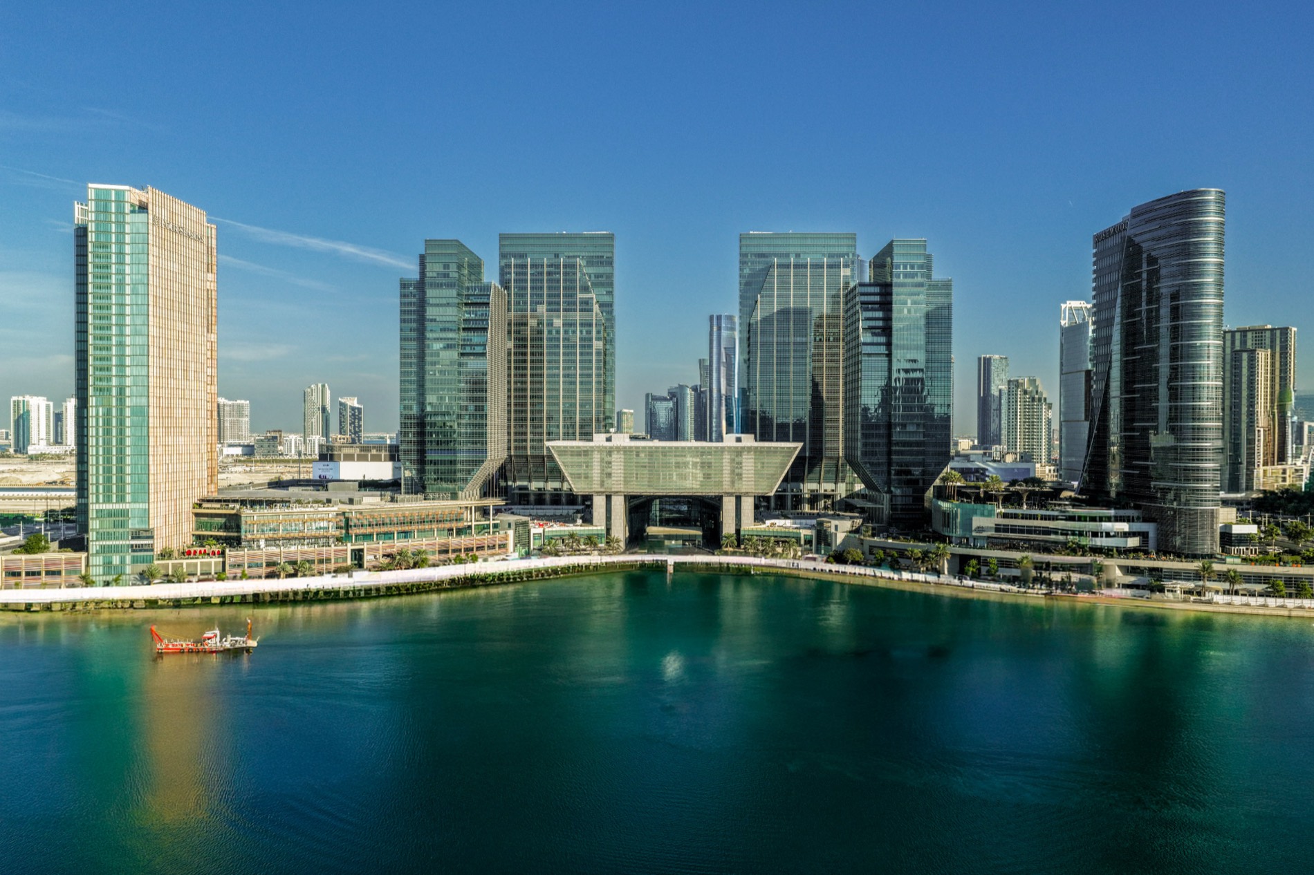Al Maryah Island, Abu Dhabi, seen across the water, with the financial district towers and The Galleria behind.